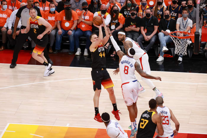 Bojan Bogdanovic (44) scores over Marcus Morris (8)